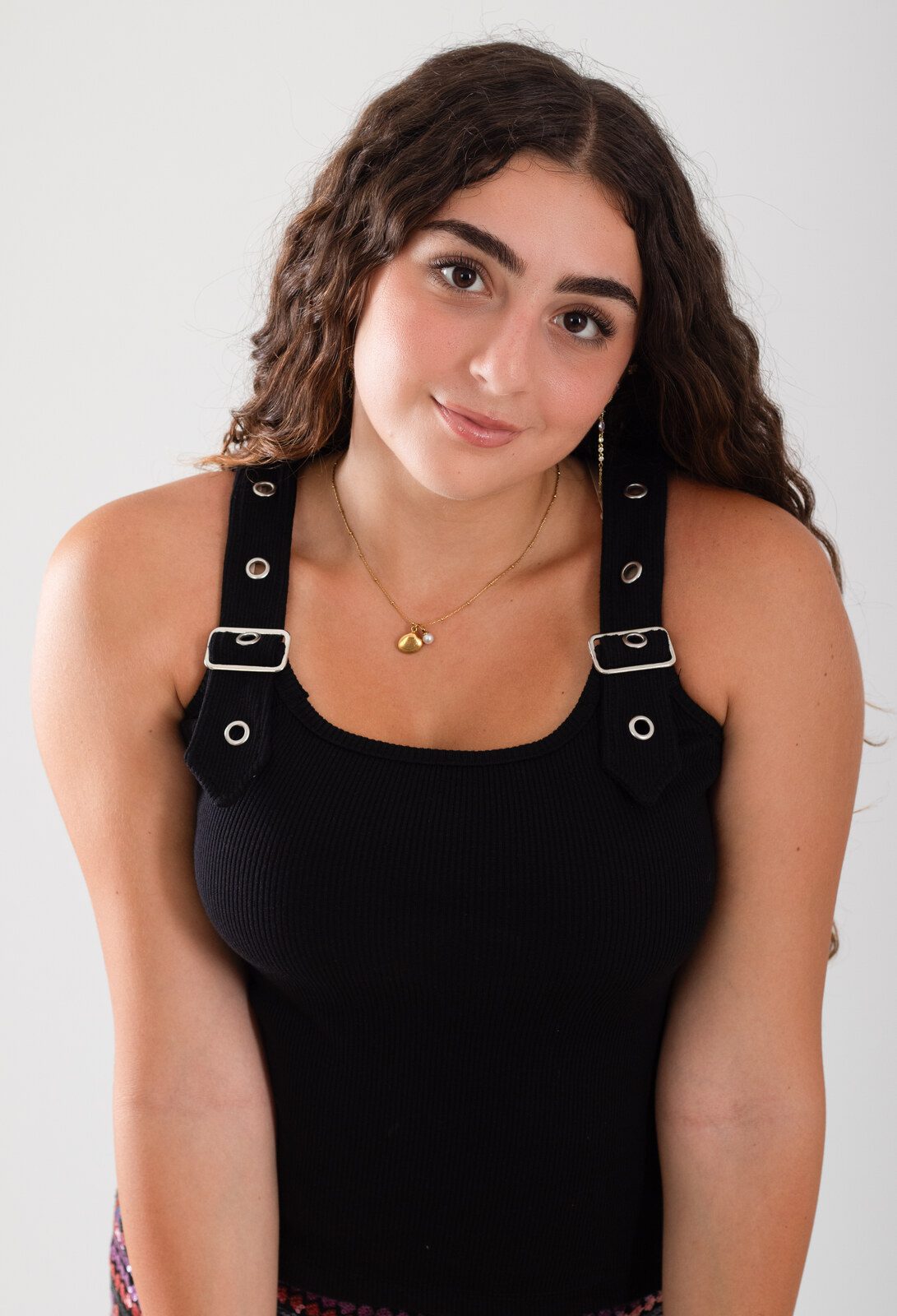 Black buckle strap ribbed tank top worn with sequin mini skirt